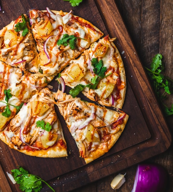 Freshly baked chicken pizza with cilantro.